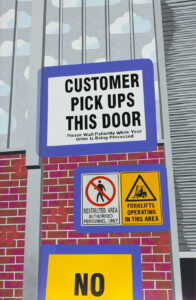 Painting of the back of a warehouse roller door with signage