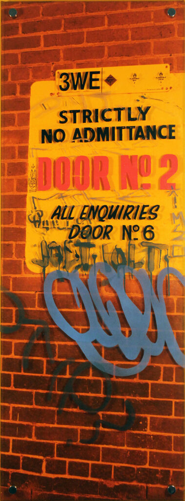 Artwork of old signage and graffiti on a brick wall in Richmond, Victoria